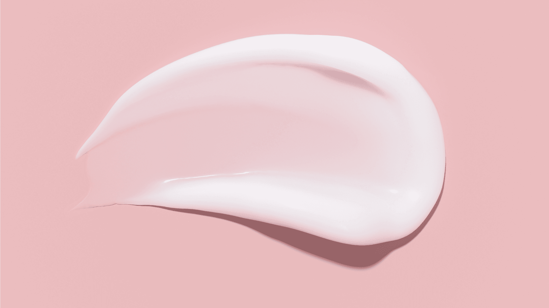 White cream on a pink background