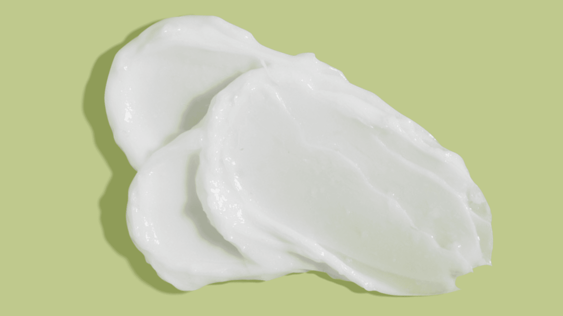 Thick white cream on a lime background