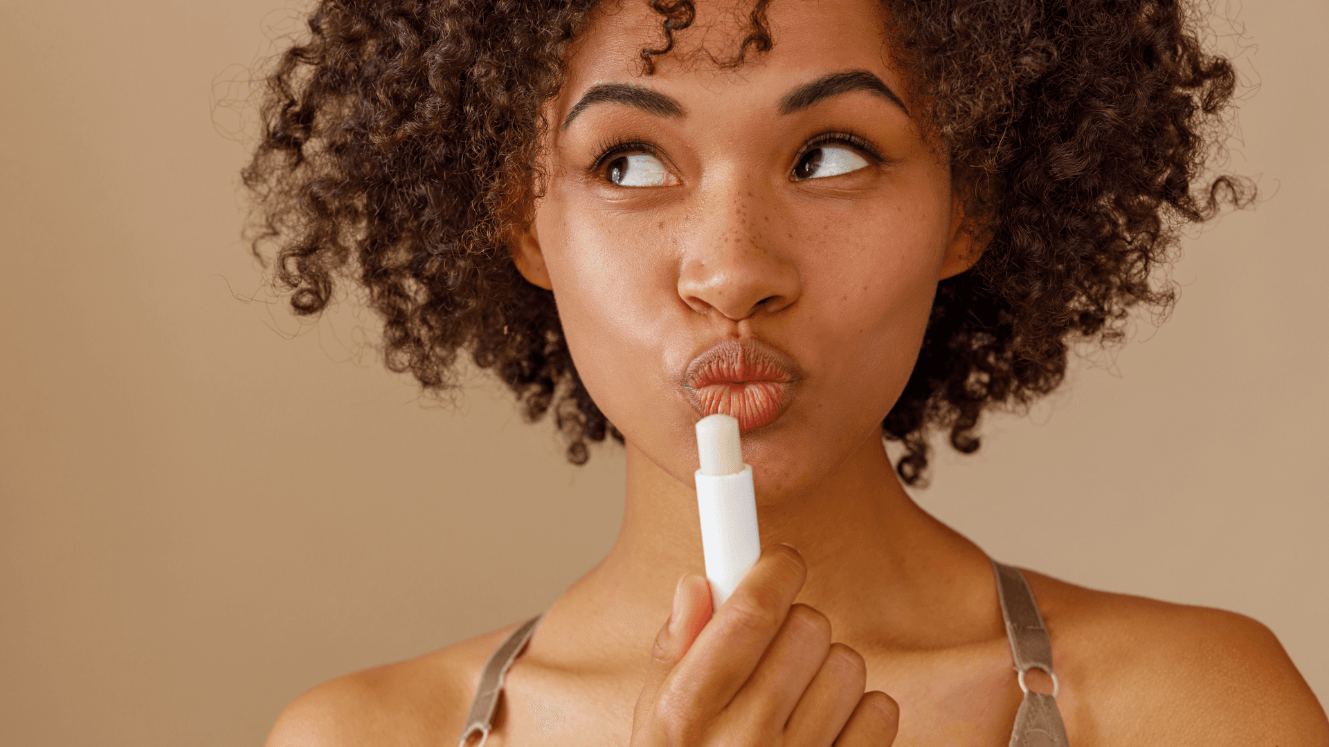 Woman applying lip balm